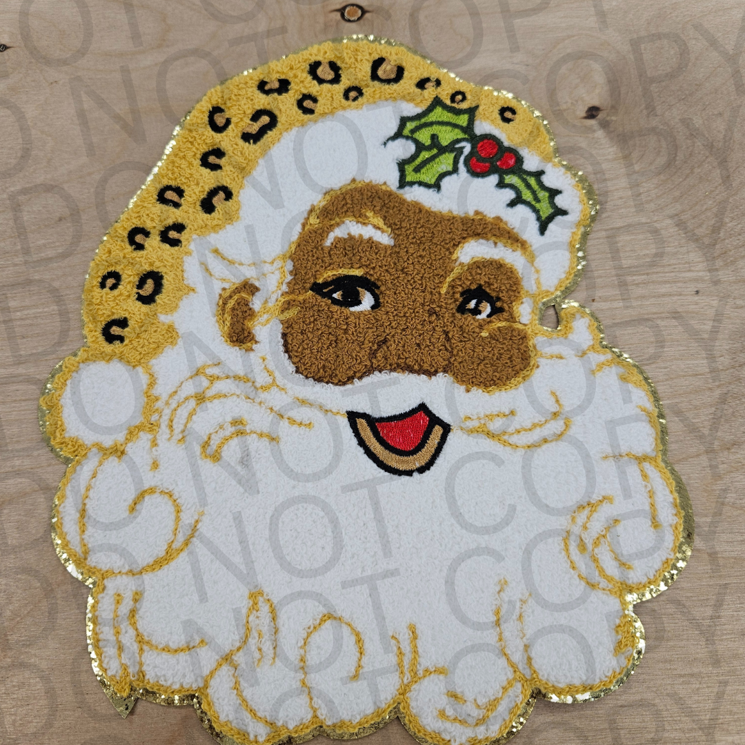 Decorative patch of a cartoon character with a festive design on a wooden surface.