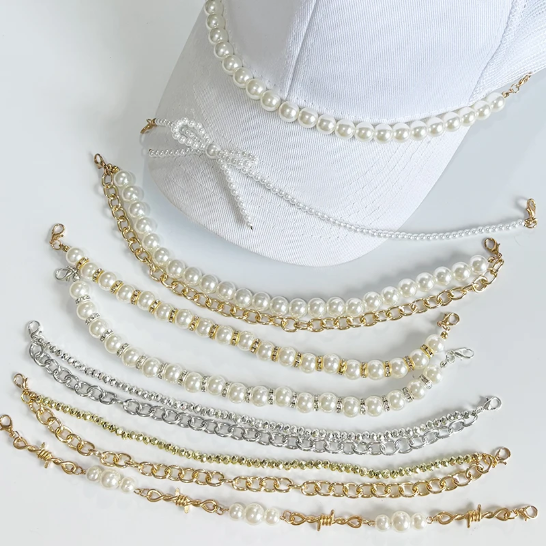 Set of pearl anklets in gold, silver, and white on a white background