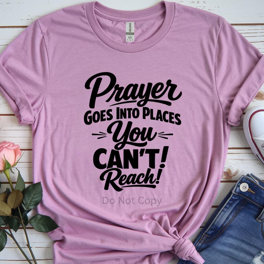 Pink t-shirt with motivational quote on a wooden surface with flowers and jeans.