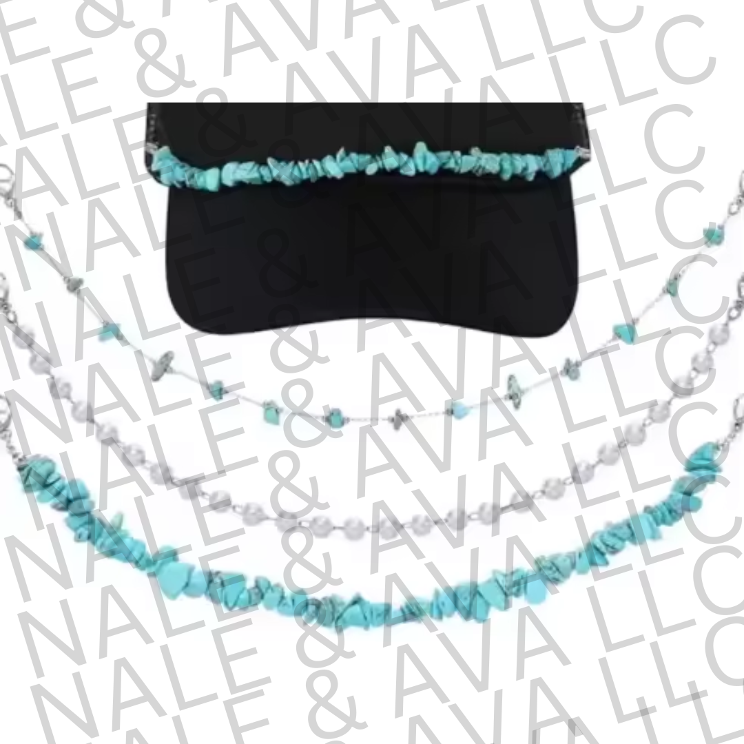 Black visor with turquoise and white beaded chain on a branded background