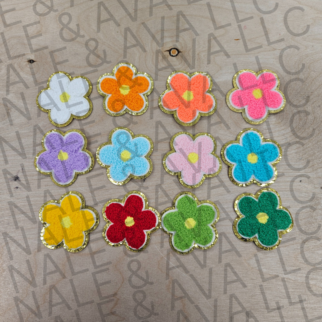 Colorful flower-shaped objects on a textured surface with 'Nail &' branding.
