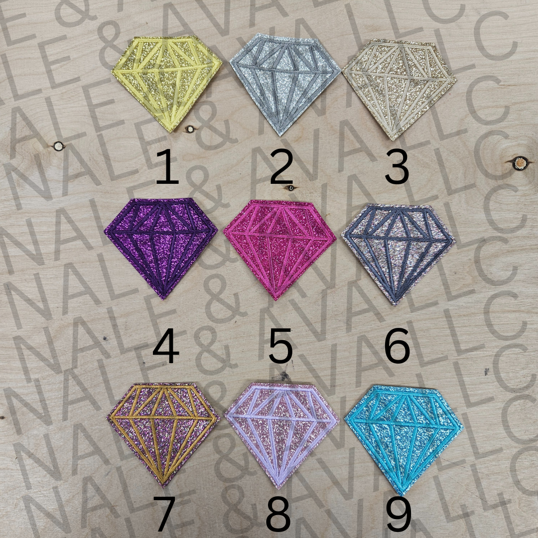 Nine diamond-shaped patches in various colors on a textured surface with text.