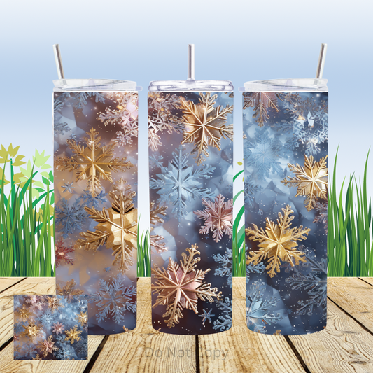 A set of three 20oz straight sublimation tumblers with a snowflake pattern in gold and blue colors.