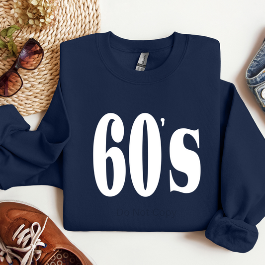 Navy blue sweatshirt with '60s' text on a white surface with accessories.
