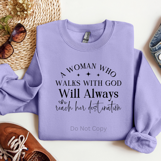 Purple sweatshirt with motivational quote on a white surface with accessories.