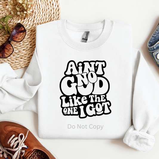 White sweatshirt with text 'Aint no god like the one I got' on a white background