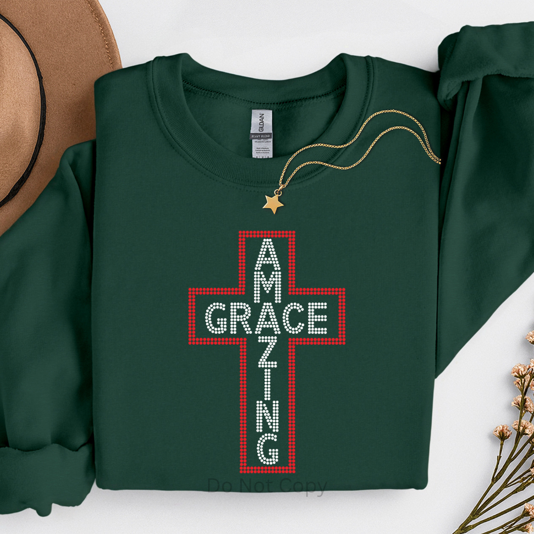 Green sweatshirt with a red cross design and text on a white background