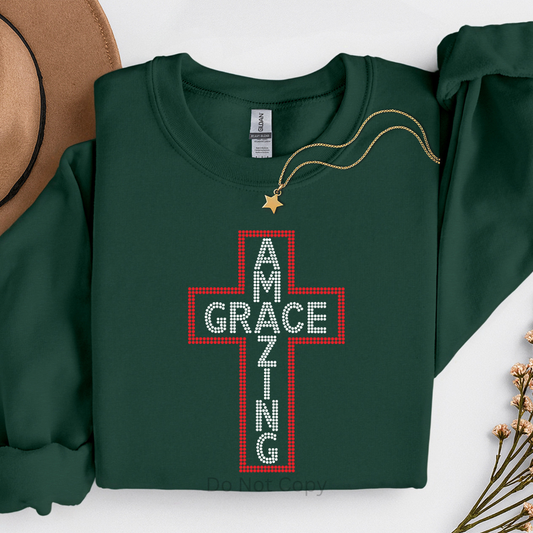 Green sweatshirt with a red cross design and text on a white background