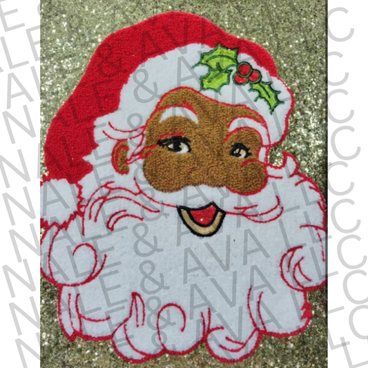Embroidered patch of a Santa  wearing a Santa hat on a glittery background.