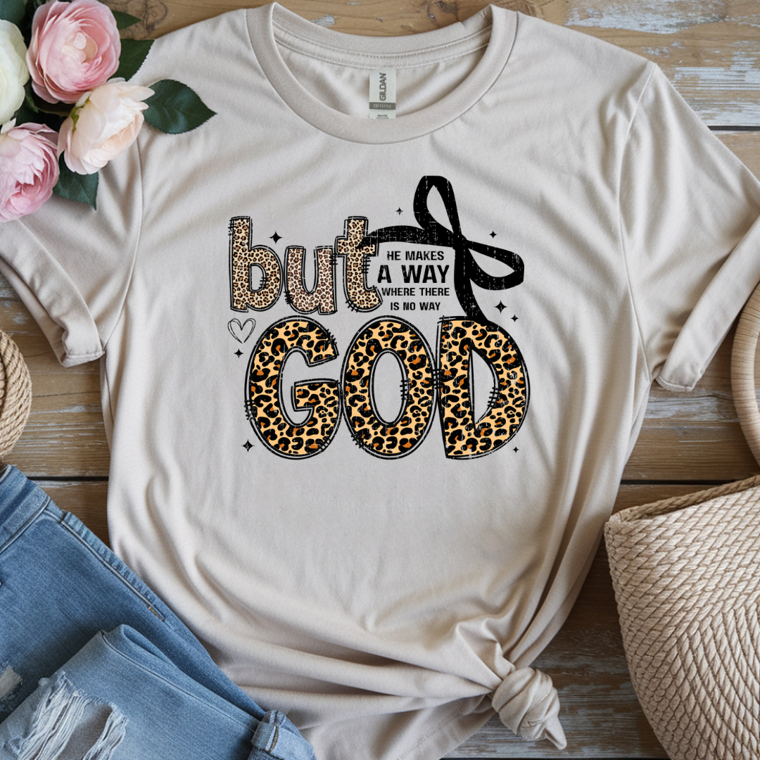 Beige t-shirt with motivational quote and leopard print design on a wooden surface with flowers and jeans.