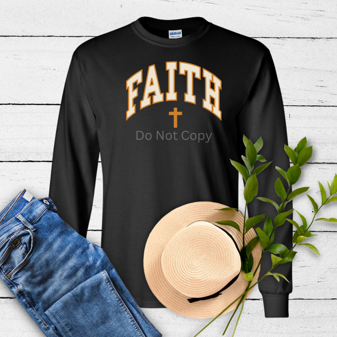A black long-sleeve shirt with the word 'FAITH' printed in capital letters, accompanied by a cross symbol and the phrase 'Do Not Copy'. The shirt is presented flat alongside a fabric roller, a heat gun, and some greenery for scale.