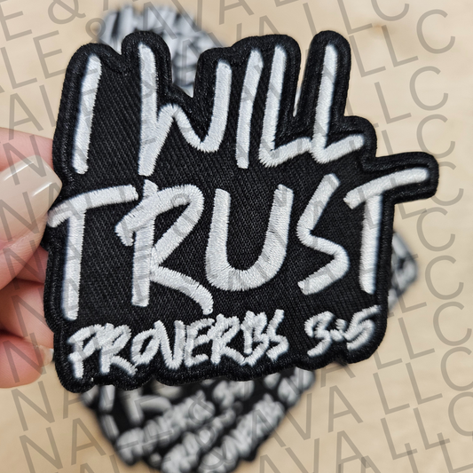 Black and white patch with 'I will trust Proverbs 3:5' text held by a hand on a beige background.
