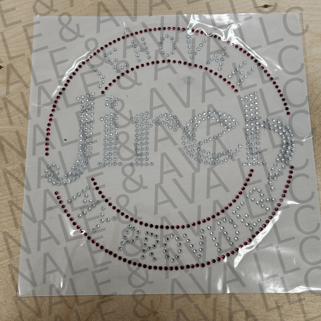 Decorative iron-on patch with rhinestone design on a branded paper background