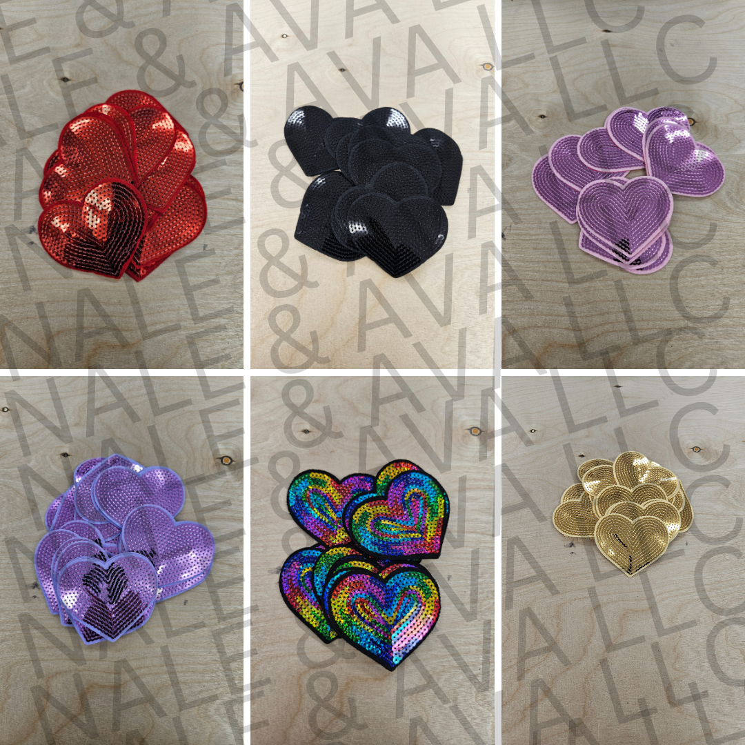 Collage of various heart-shaped sequin patches in different colors on a textured surface.