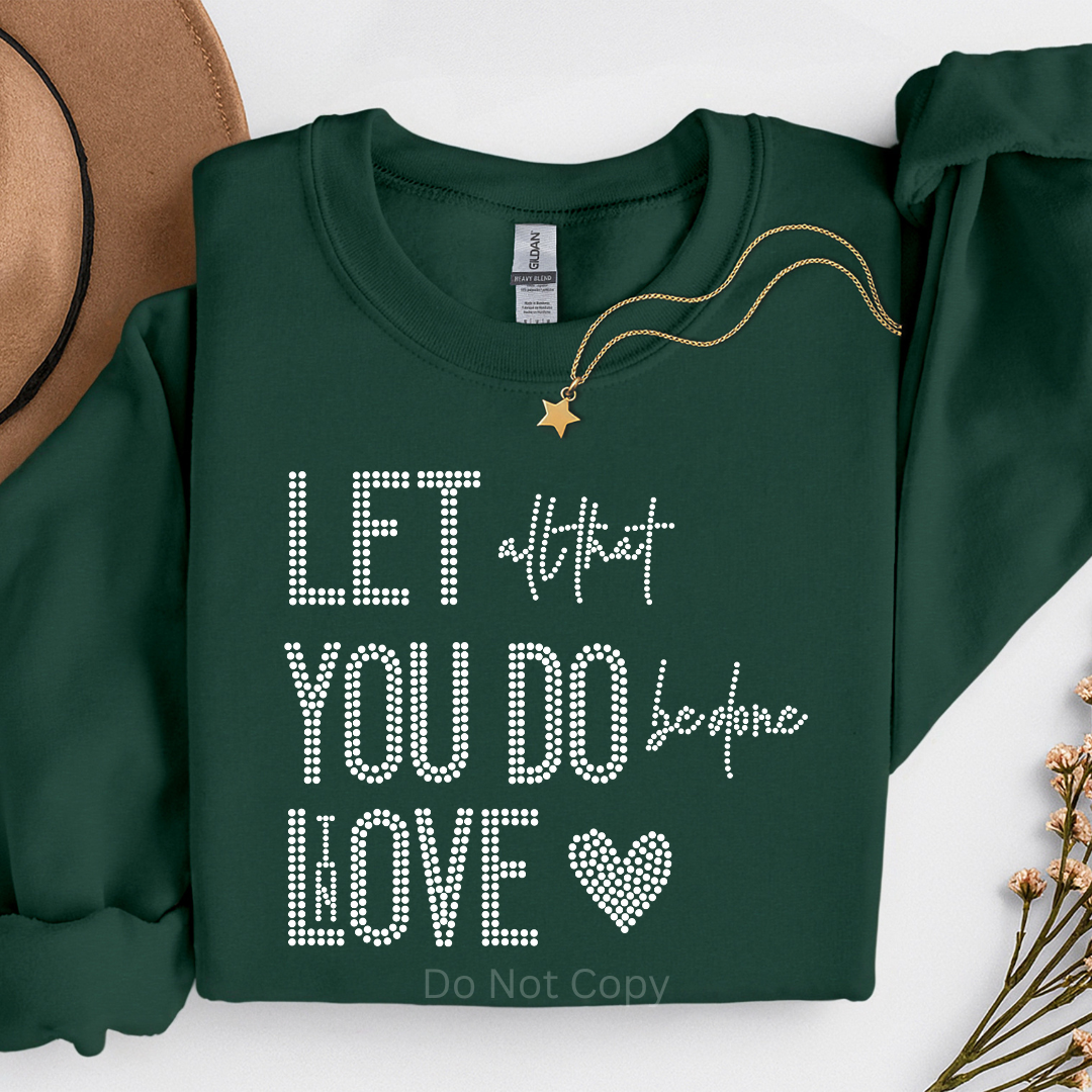 Green sweatshirt with decorative text and a necklace on a white background