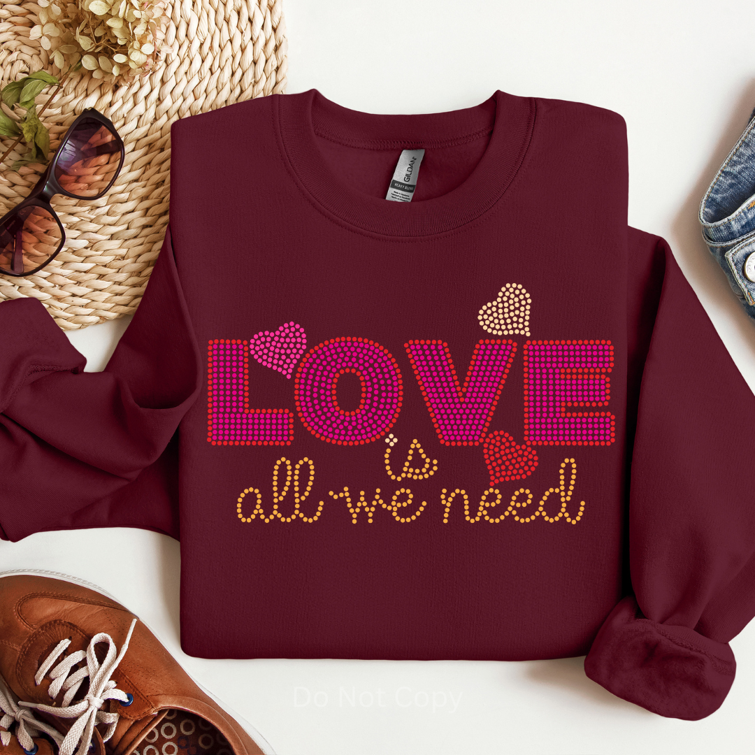 Love Is All We Need Rhinestone Transfer on a burgundy tshirt front side
