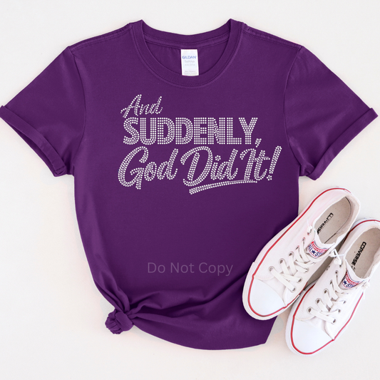 Purple t-shirt with 'And Suddenly, God Did It!' text and white sneakers on a white background