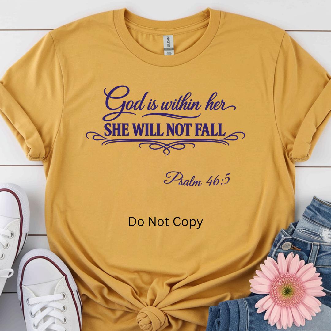 Yellow t-shirt with purple text 'God is within her SHE WILL NOT FALL Psalm 46:5' on a white wooden surface with shoes and a flower.