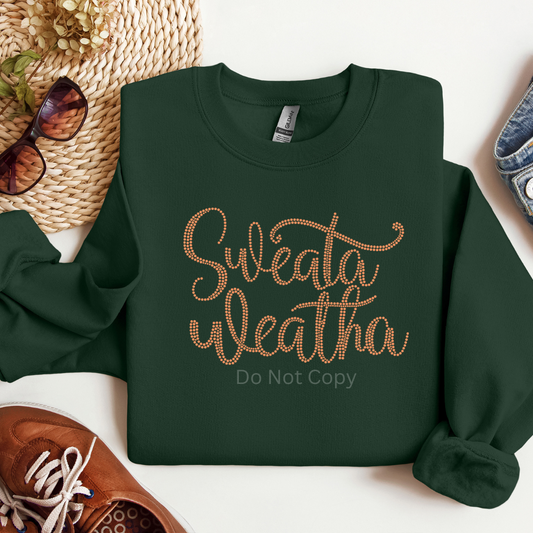 Green sweatshirt with 'Sweata Weatha Do Not Copy' text on a white surface with accessories.