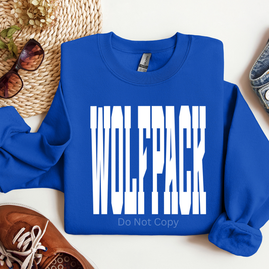 Blue sweatshirt with 'WOLFPACK' text on a white surface with accessories around