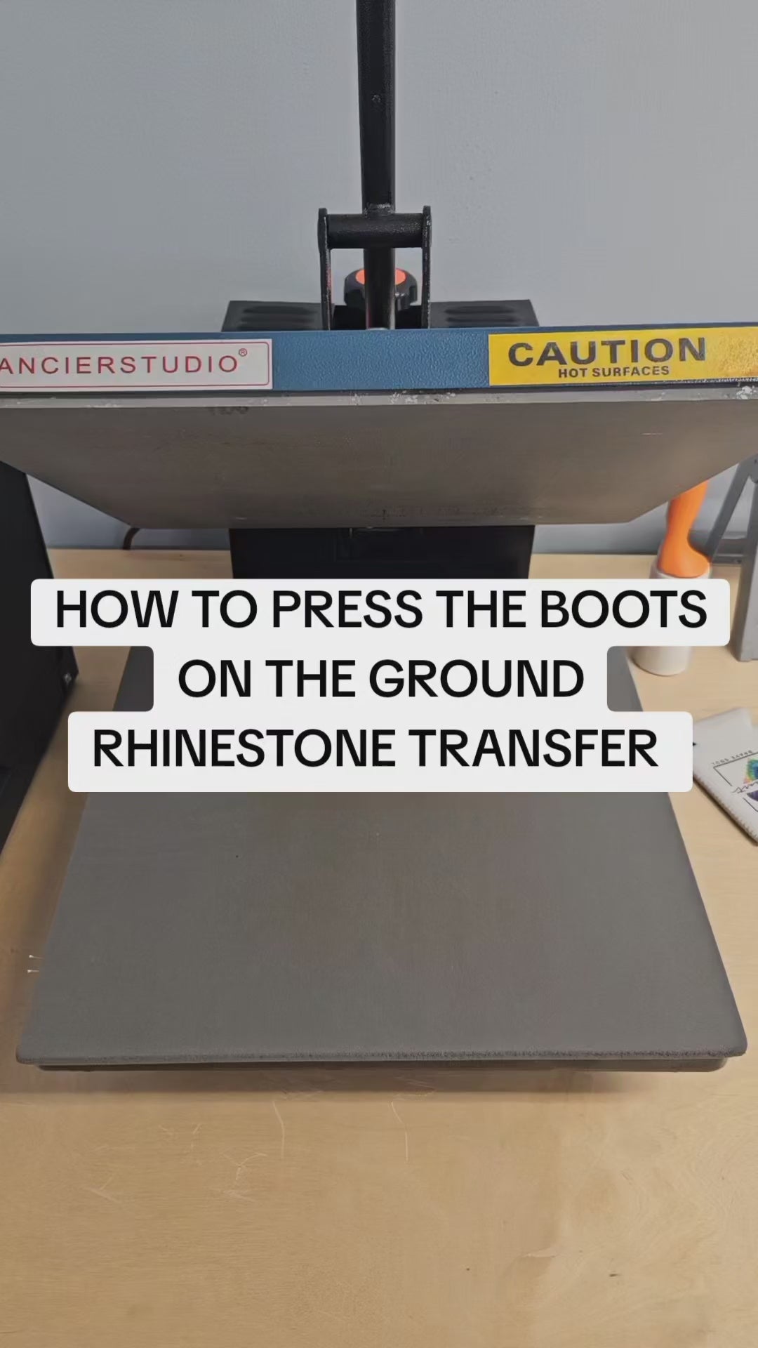 Step-by-step tutorial showing how to apply the ‘Boots on the Ground’ rhinestone transfer using a heat press on a cotton t-shirt. Includes temperature, pressure, and peel instructions.