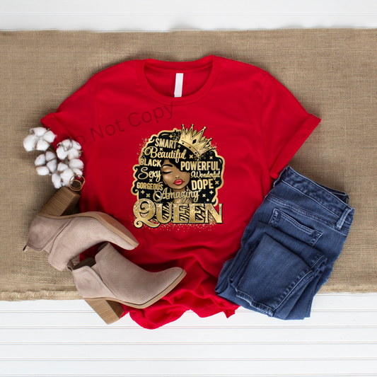A red shirt with a gold DTF transfer that reads 'Queen' and has a graphic of a crown, accompanied by blue jeans and a pair of brown shoes.